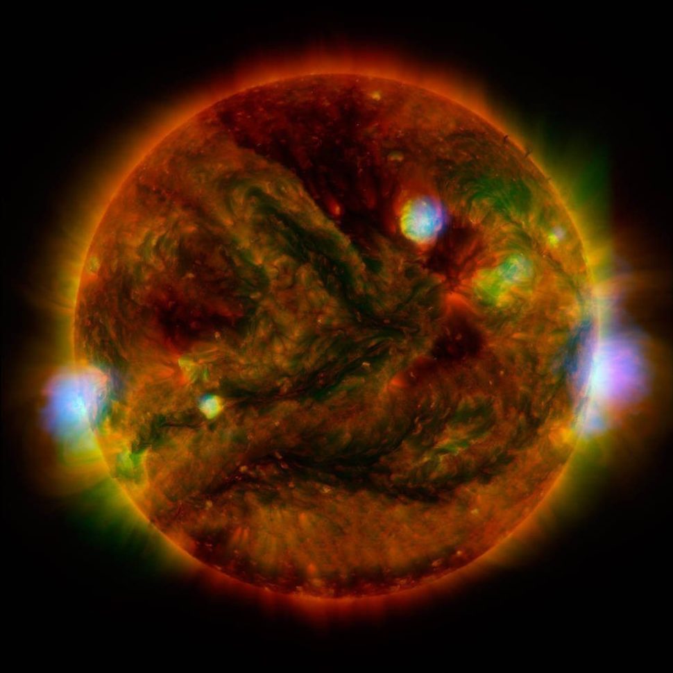 Flaring, active regions of our sun are highlighted in this new image combining observations from several telescopes. High-energy X-rays from NASA's Nuclear Spectroscopic Telescope Array (NuSTAR) are shown in blue; low-energy X-rays from Japan's Hinode spacecraft are green; and extreme ultraviolet light from NASA's Solar Dynamics Observatory (SDO) is yellow and red. |
NASA | JPL-Caltech | GSFC | JAXA